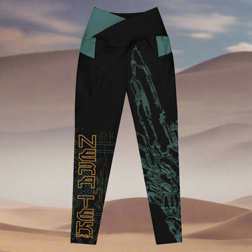 A pair of black leggings with green accents and a green and yellow geometric pattern design based on XeneDragon's generation three DRGN. The leggings have pockets and the word "NERATEK" is written on one leg.
