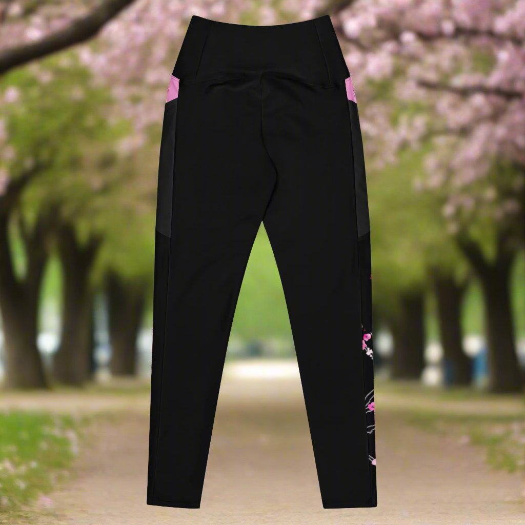 A pair of black leggings with pink accents. This picture shows the back of the design of the leggings.