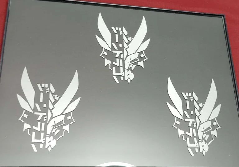 Three dragon decals in a picture frame featuring XeneDragon's Generation 1.1 DRGN design. Picture is taken in bright lighting to show the reflective differences between the materials.