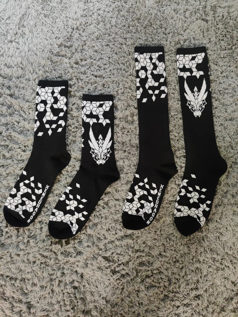 Two pairs of black socks with white geometric designs and the XeneDragon Logo. The crewcut is shorter than the knee high socks.