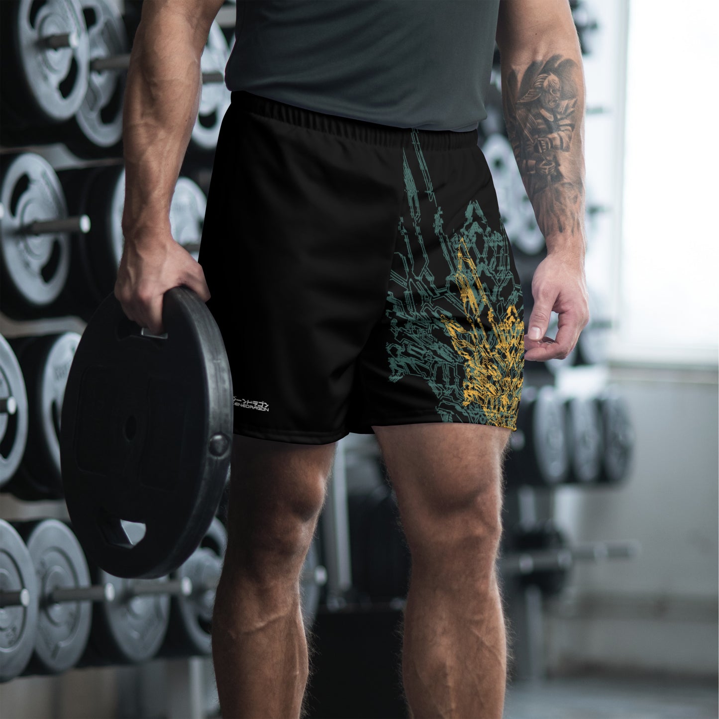 A male athletic model wearing a pair of black athletic shorts with green and yellow geometric pattern design based on XeneDragon's generation three DRGN.
