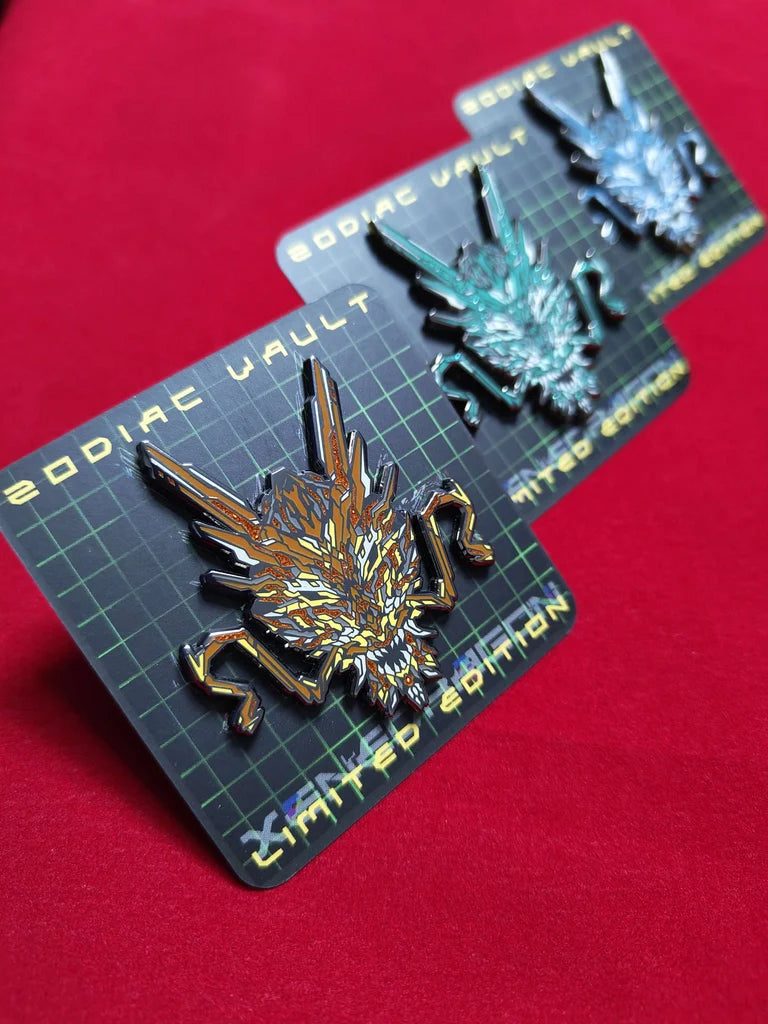 Three limited edition enamel pins with vibrant geometric designs celebrating the Year of the Dragon. The pins are displayed on black cards with the text "ZODIAC VAULT" and "LIMITED EDITION."