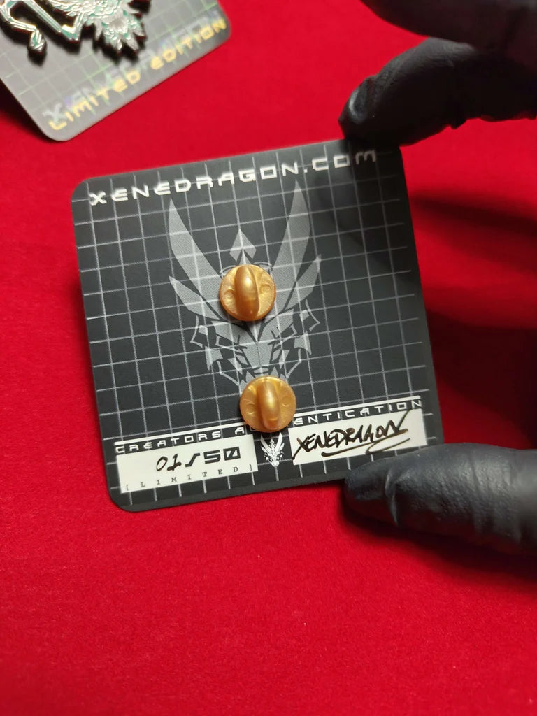 The back of a card displaying two gold-colored backing. The card includes text such as "XENEDRAGON.COM," "CREATORS AUTHENTICATION," and "01/50 LIMITED." The card is also signed by XeneDragon.