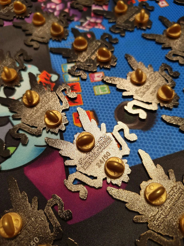 A collection of limited-edition pins showing the back stamp that says "LIMITED EDITION XENEDRAGON" and the assigned number for each pin.