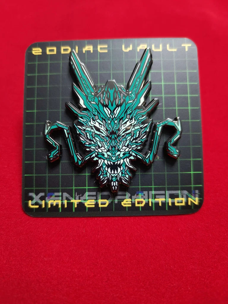 A limited edition enamel pin with vibrant geometric design celebrating the Year of the Dragon. The pin features a stylized image of a dragon's head in green and white color scheme with special glitter accents. The backing paper for the pin says "ZODIAC VAULT LIMITED EDITION"