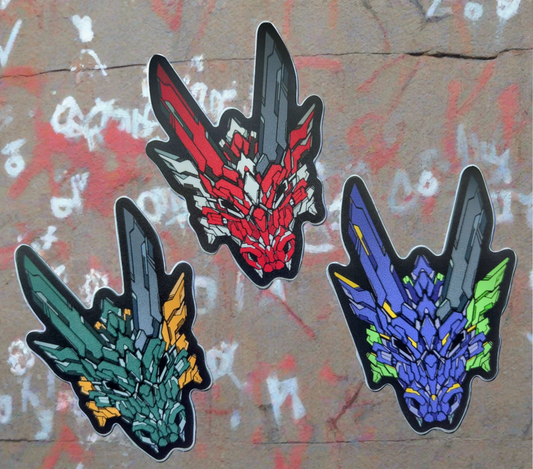 Three stickers in XeneDragon's Generation Three DRGN designs. One of them is green with yellow accents. Another is red with white accents. The last one is purple with green accents.