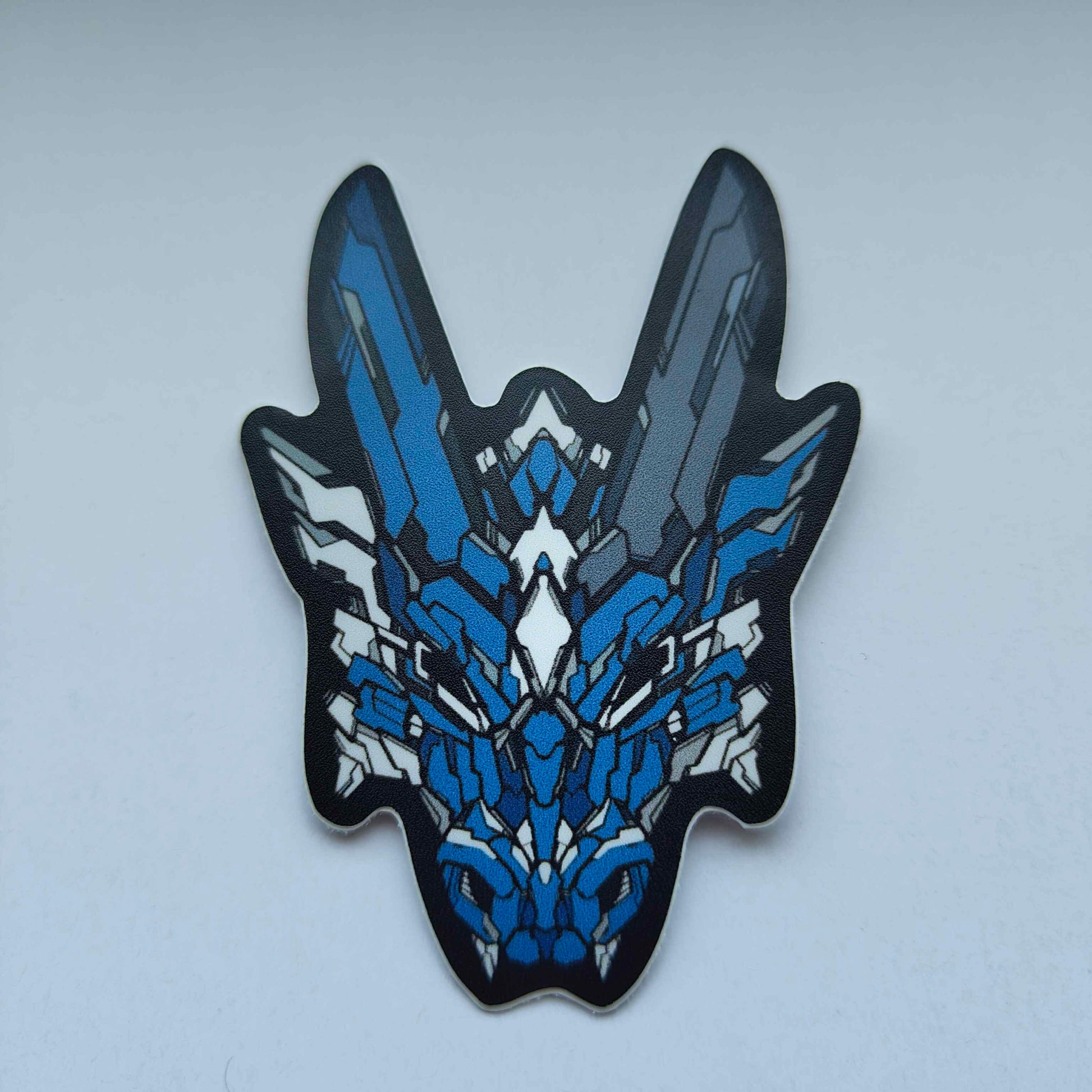 A sticker in XeneDragon's Generation Three DRGN design, the dragon head colors are blue with white accents.