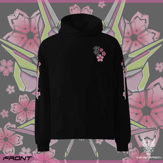 The front of the black hoodie displays the Japanese text "タマ" which is the Monster's name and three geometric japanese cherry blossoms on the left chest area