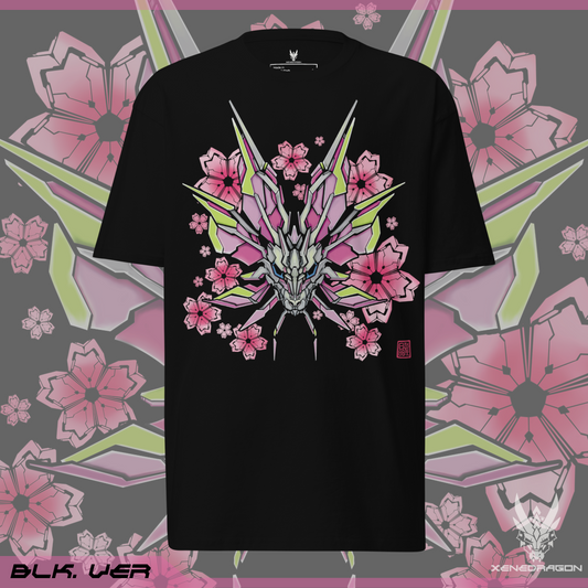 The front of the black shirt shows a design of a stylized monster's head. The design features vibrant colors like pink, yellow, and blue. There are geometric Japanese cherry blossoms within the background. Designed by XeneDragon