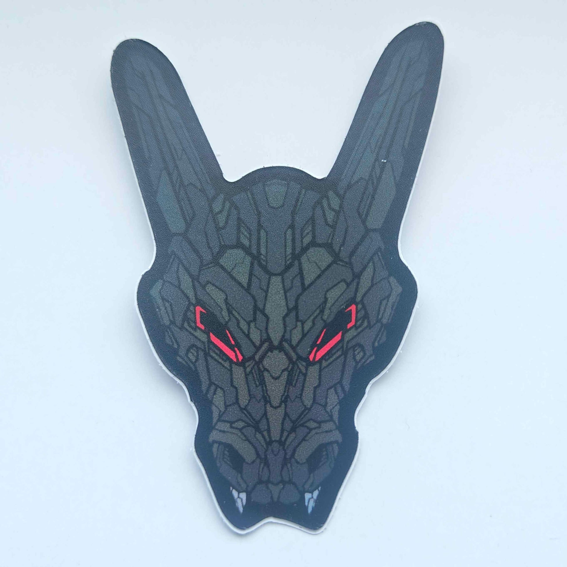 A special iridescent effect sticker with a detailed design of a stylized dragon's head. The design features a dark color scheme with red glowing eyes. Designed by XeneDragon.