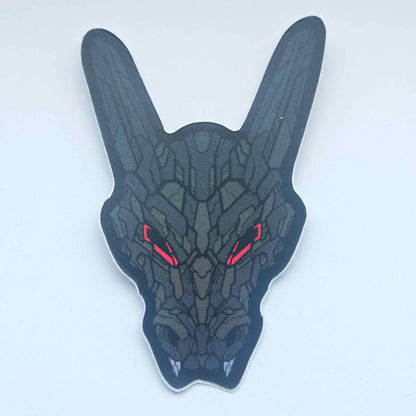 A special iridescent effect sticker with a detailed design of a stylized dragon's head. The design features a dark color scheme with red glowing eyes. Designed by XeneDragon.