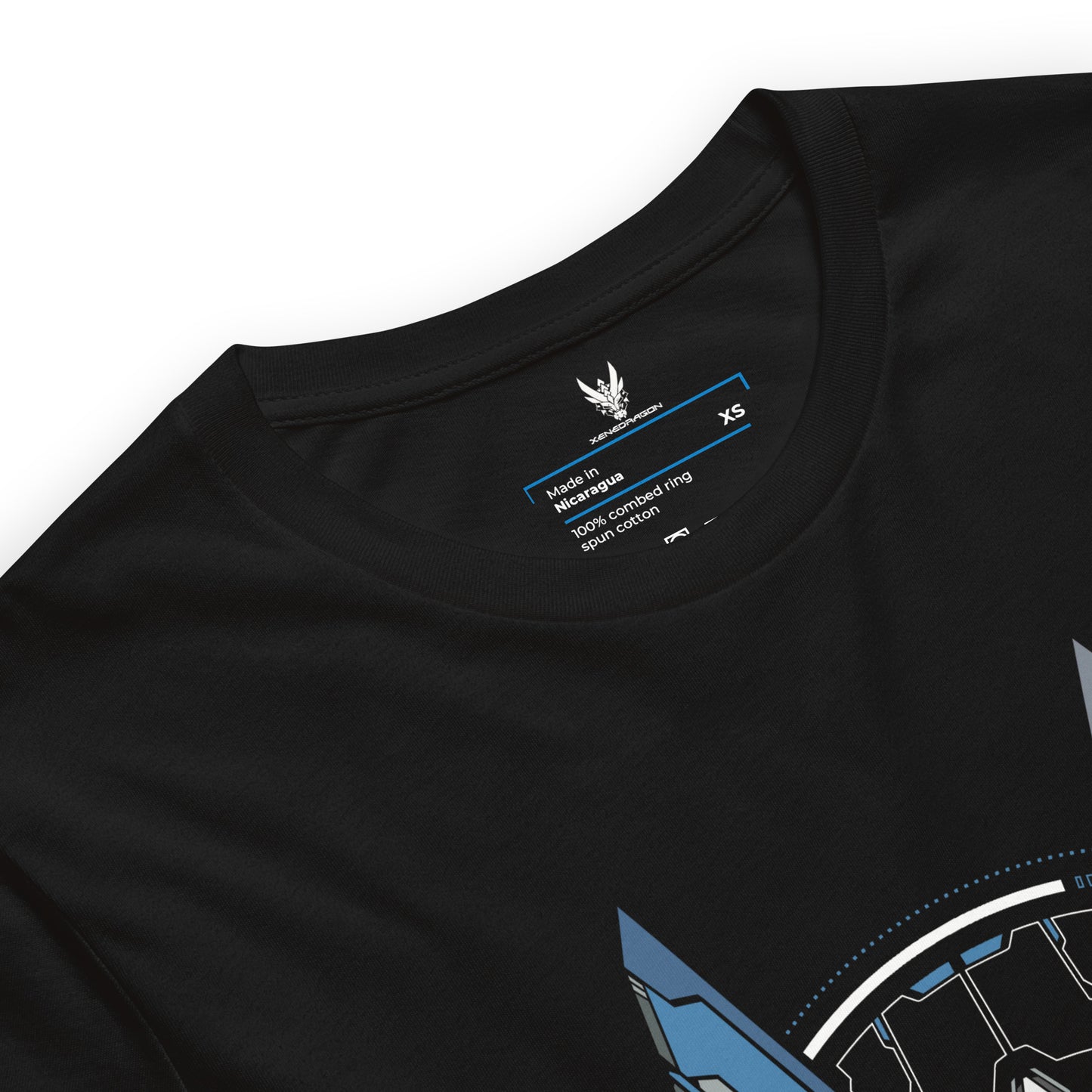 A close-up of the neck tag of a black t-shirt. The tag shows XeneDragon Logo, the size and other specifications of the shirt. The design is white text with blue accents.